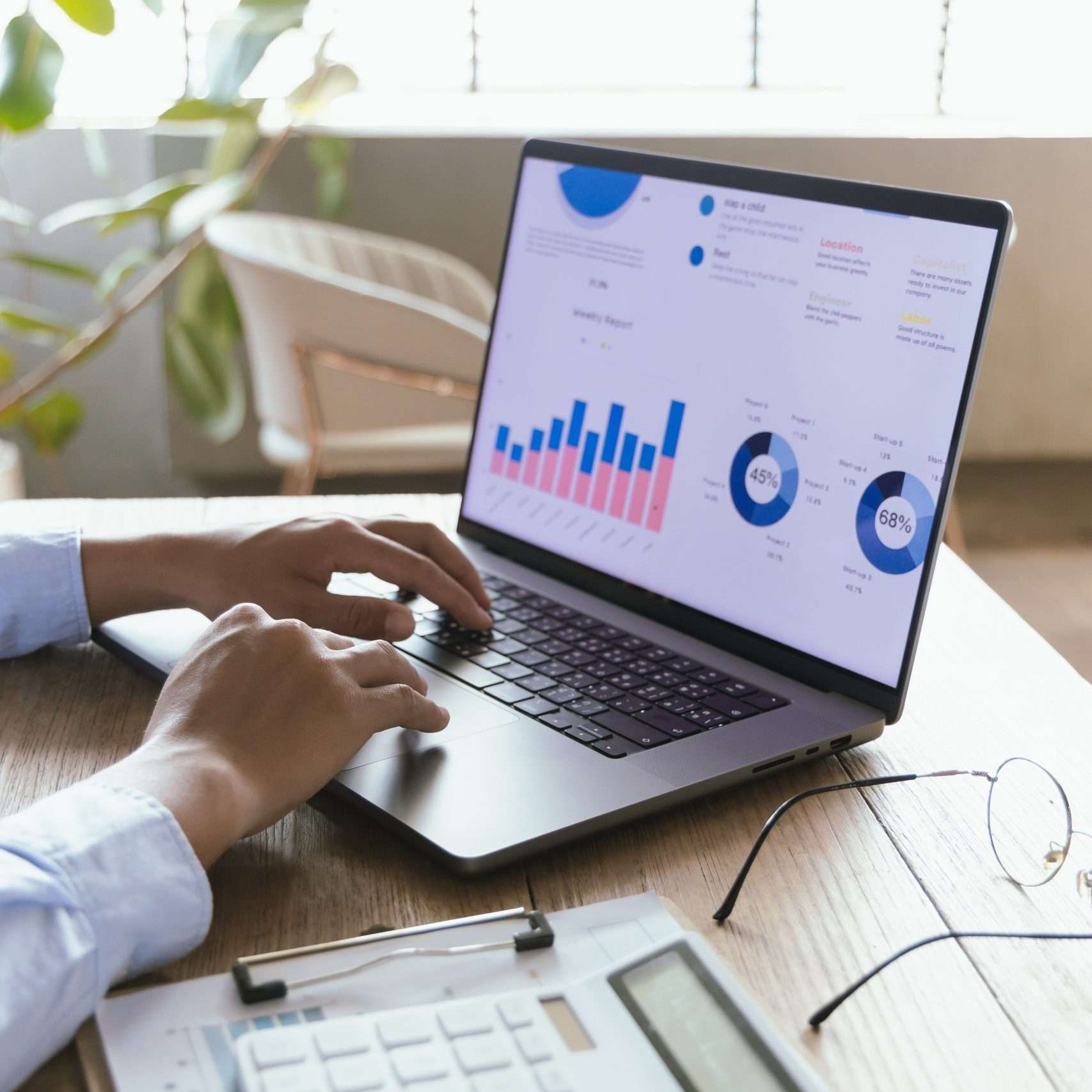 Professional businessman working on laptop to analyze financial charts and documents for investment planning, technology, strategy, accounting and efficiency in modern office.