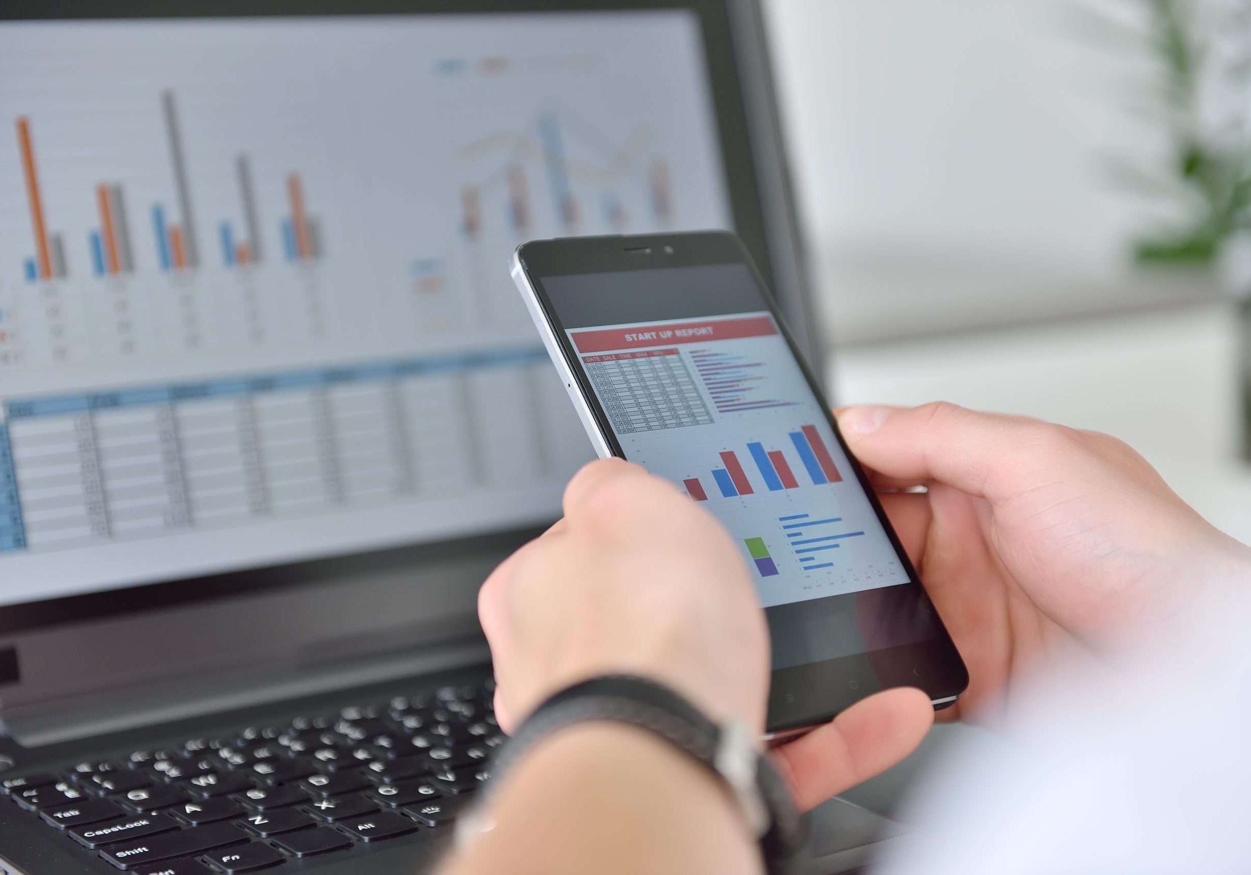 Businessman checks business report on cellphone. Business and financial success concept. Close up