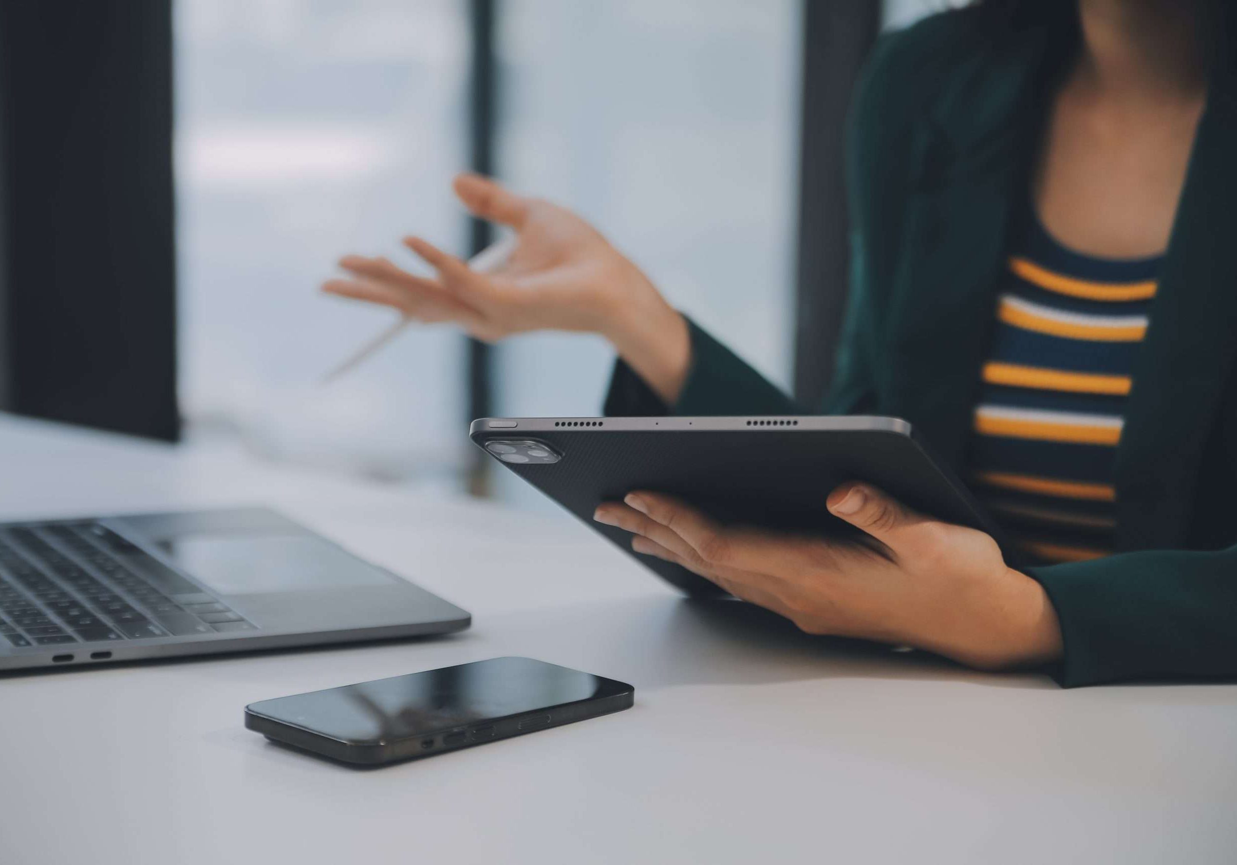 Charming Young asian businesswoman sitting on laptop computer in the office, making report calculating balance Internal Revenue Service checking document.